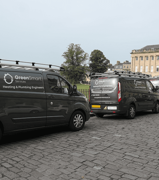 Two GreenSmart Services heating and plumbing engineer vans parked at the Royal Crescent in Bath.